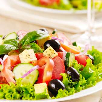 Greek salad on the oak table